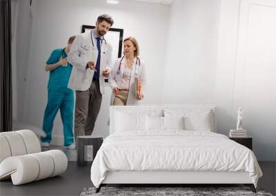 Doctors discussing medical result of patient in clinic Wall mural