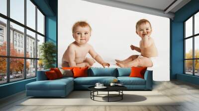 Full length of cute babies sitting isolated on white background Wall mural