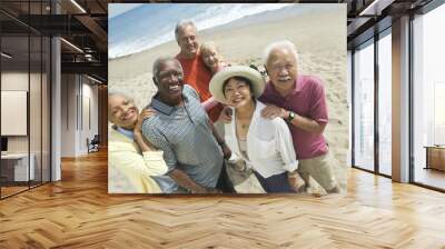 Group portrait of happy multiethnic couples smiling on the beach Wall mural