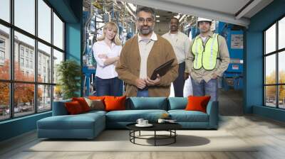 Group portrait of multiethnic operators standing in the factory Wall mural