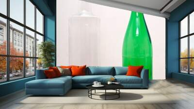 one green glass bottle and one clear glass bottle Wall mural