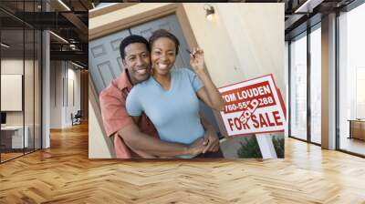 Portrait of a cheerful African American couple with keys of their new house Wall mural