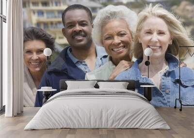 Portrait of happy multiethnic friends standing together in a row Wall mural