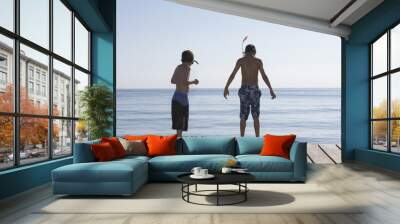 Rear view of two boys with snorkeling masks on jetty Wall mural