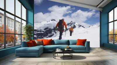 Rear view of two hikers joined by safety line in snowy mountains Wall mural