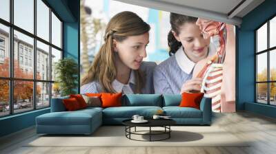 Teenage girls examining part of anatomical model in classroom Wall mural