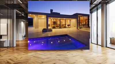 View inside modern home with swimming pool at dusk Wall mural