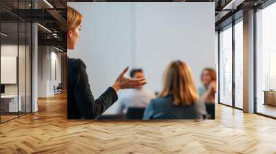 Businesswoman giving a presentation at business meeting. Audience in the conference hall. Business and Entrepreneurship concept, view of businesswoman pointing at flipchart during a presentation. Wall mural