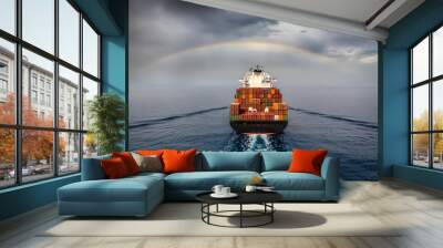 Aerial view of a container cargo ship sailing into bad weather with a rainbow in the cloudy sky Wall mural