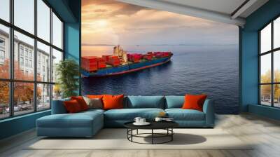 Aerial view of a large, loaded container cargo ship sailing over calm sea into the sunset with copy space Wall mural