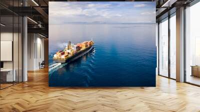 Aerial view of a loaded cargo container ship traveling over calm ocean towards the next commercial port Wall mural