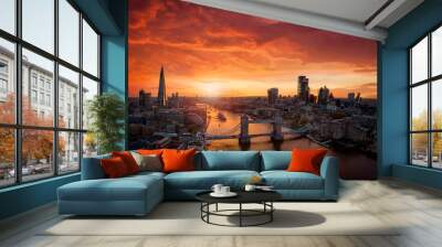 Aerial view of colorful sunset behind the modern skyline of London, United Kingdom, along the Thames river with Tower Bridge and skyscrapers of the City Wall mural