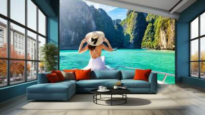 Elegant traveler woman in summer dress relaxing on boat at Maya beach, Phi Phi island, Tourism Phuket, Krabi, Travel concept for Thailand Wall mural