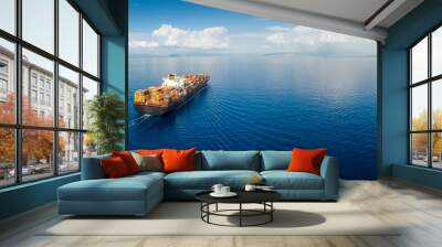 panoramic aerial view of a industrial cargo container ship traveling over calm, open sea with copy s Wall mural