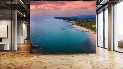 Panoramic sunset view of the beautiful coast of Khao Lak, Thailand, with turquoise sea next to fine sandy beaches and palm trees Wall mural