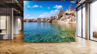 The emerald sea at the Vaporia district, city of Ermoupoli at Syros island, Cyclades, Greece, during a sunny summer day Wall mural