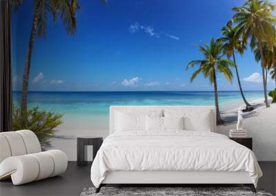 Wide panorama view of a tropical paradise beach with turquoise sea, coconut palm trees and fine, white sand Wall mural