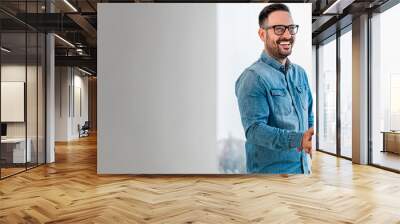 Businessman greeting job applicant businessmen handshaking over signed contract handsome entrepreneur handshake with a colleague cheerful young manager handshake with new employee getting a deal done Wall mural