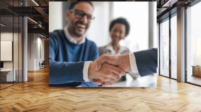 Happy businessman shaking hands with partner on successful deal at office Wall mural