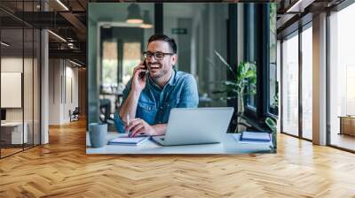 Joyful caucasian man, making a phone call to his boss. Wall mural