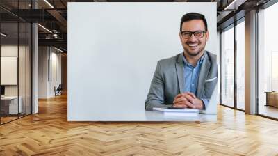 Portrait of young smiling cheerful businessman in office looking at camera copy space Wall mural