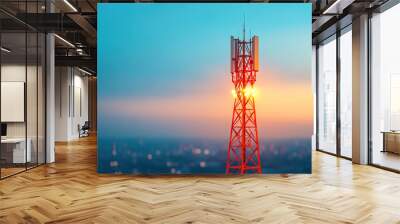 A close-up view of a telecommunications tower during sunset, radiating light against a colorful sky. Wall mural