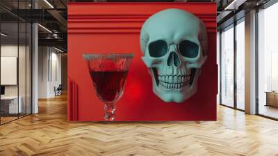 A decorative skull and a stylish glass of red drink are displayed against a bold red wall, creating a striking visual contrast. Wall mural