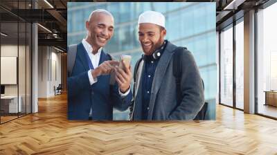 Business, smartphone and men in city, conversation and online reading to share ideas. Corporate, Islamic male and friends in town, cellphone and discussion for social media, typing and connection Wall mural