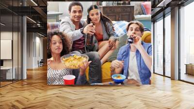 Friends, drink and snacks and watching tv, relax and beer in living room, diversity and sports together in home. Men, women and people watch television, sports and streaming subscription with alcohol Wall mural