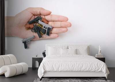 Model police car with tiny model many types of gun in hand on white background, Crime Scene       Wall mural