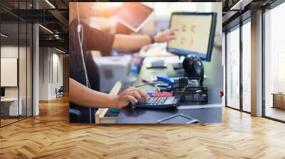 business man using calculator with doing finance at his office. Wall mural