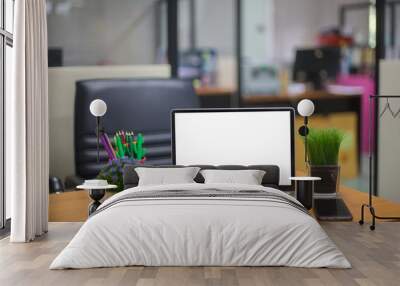 Computer laptop with white blank screen isolated  on work table in office. Wall mural