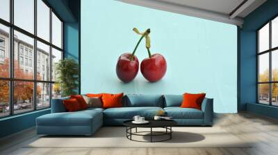 two cherries on a blue  background Wall mural