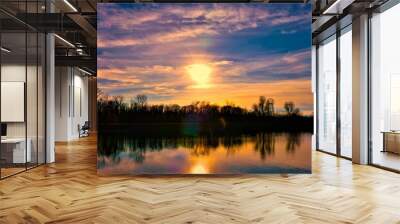 Purple sunset above the lake with colorful clouds Wall mural