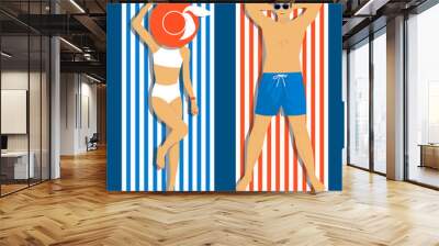 Beautiful young woman and young man sunbathing on the beach. Top view of the lying people Wall mural