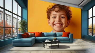 Portrait of happy joyful small caucasian boy in front of yellow background looking to the camera - Childhood growing up and concept - front view waist up copy space Wall mural