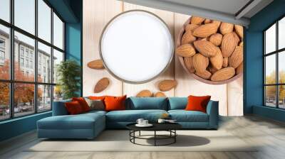 Almond milk with almond on a wooden table. Wall mural