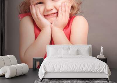 Cute little girl 3-4 year old wearing hair curlers. Looking at camera.  Wall mural