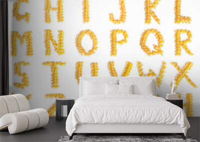 Alphabet made of macaroni letters isolated on white background Wall mural