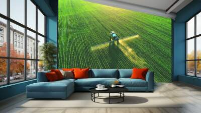 Tractor spray fertilizer on green field drone high angle view, agriculture background concept. Wall mural