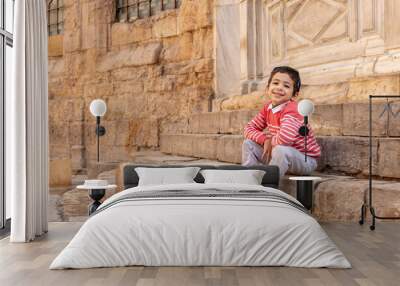 happy child visits ancient places and walking in el Meiz street, Cairo, Egypt Wall mural