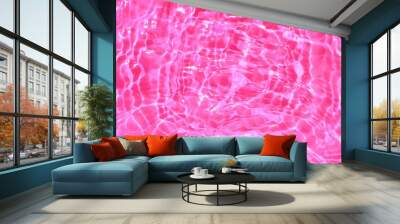 Pink water with ripples. Pink watery background with a dark natural surface and a unique watery texture, top view of sea waves, a pink watery background characterized by texture and wrinkles	 Wall mural