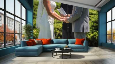 Man and woman at alter with officiate to say their vows in the wedding ceremony. Wall mural