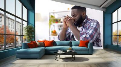 African-American man praying before lunch, thanking God for meal, religion Wall mural