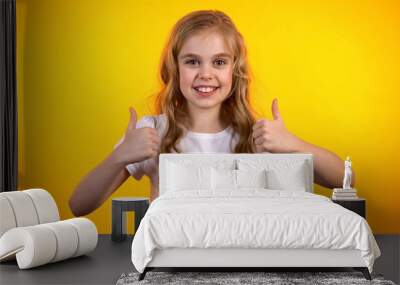 Emotional teen girl making double thumbs-up, extremely satisfied child, promo Wall mural