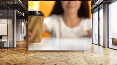 Female holding cup of coffee, morning beverage, take away from cafeteria Wall mural