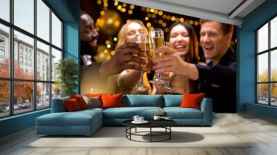 Happy multi-ethnic company clinking beverage glasses, celebrating New Year Wall mural