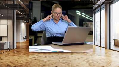 Irritated lady closing ears with fingers, noisy colleagues distracting from work Wall mural