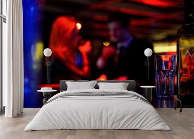 man and woman dating in nightclub, both drinking beverages, blurred background Wall mural