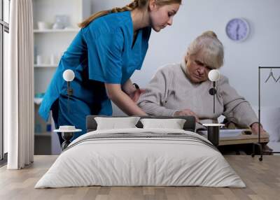 Nurse serving unappetizing diet dinner to old handicapped woman, taking care Wall mural